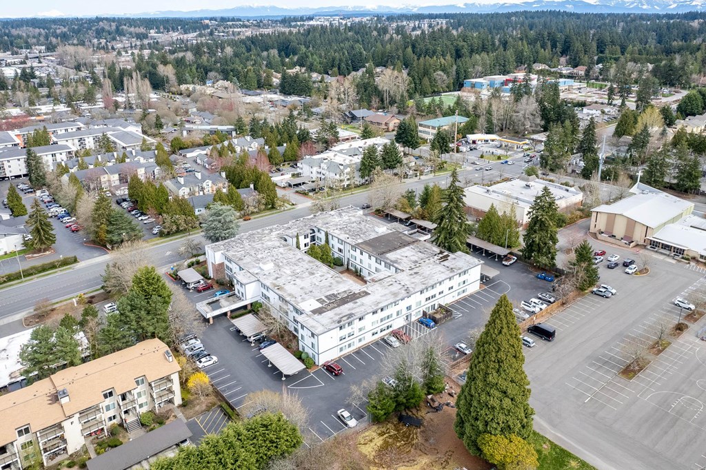 an aerial view of a large building in a parking lot